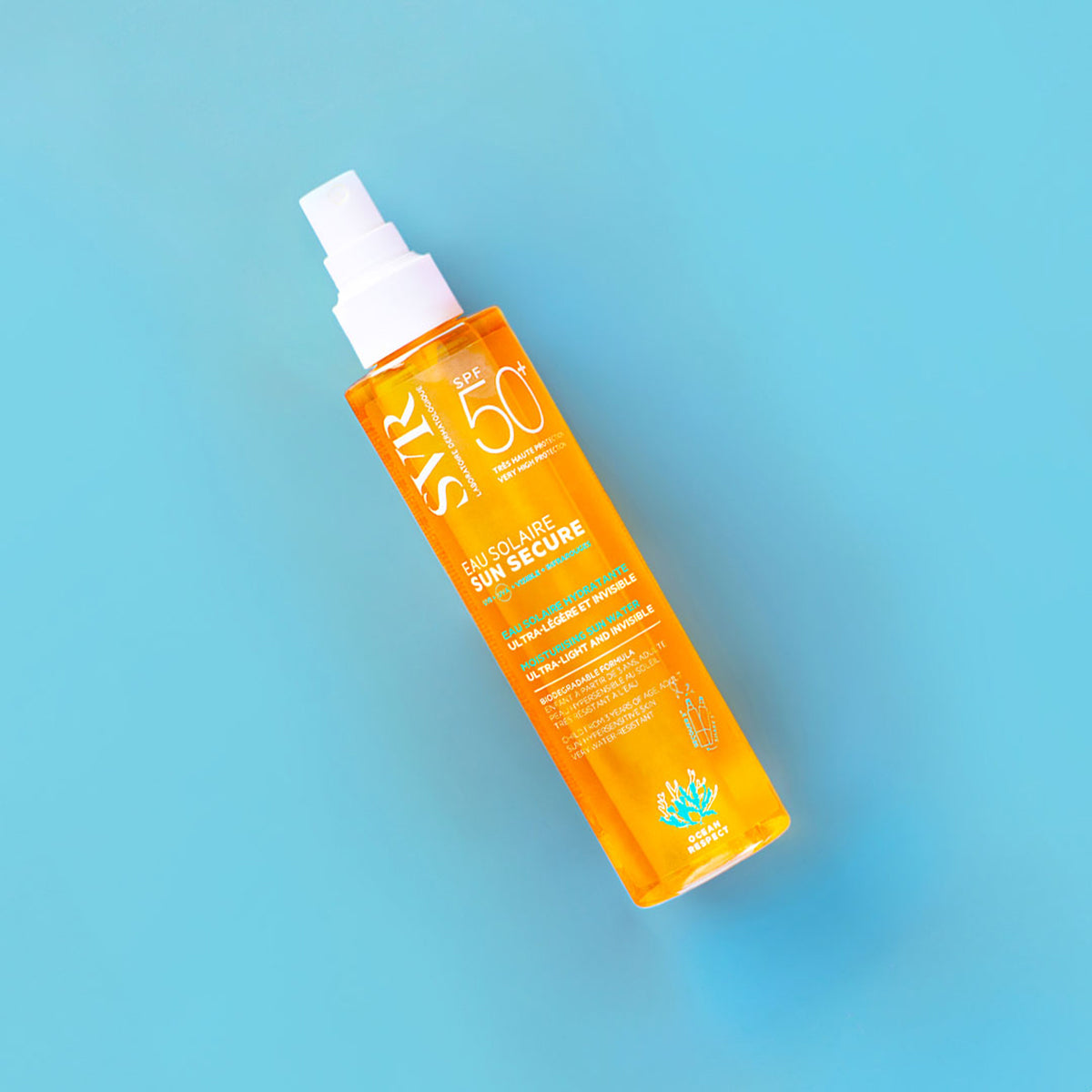 SVR SUN SECURE SPF50+ spray bottle with orange liquid in a clear plastic container on a light blue background.