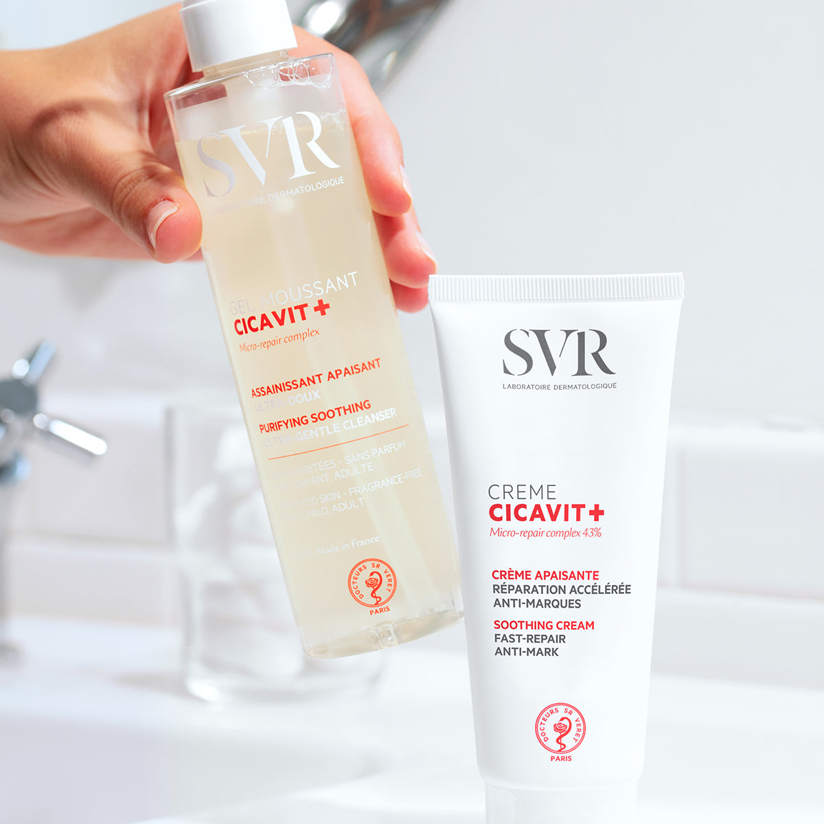 SVR Cicavit+ purifying soothing cleanser bottle and fast-repair anti-mark cream tube in a bathroom setting.