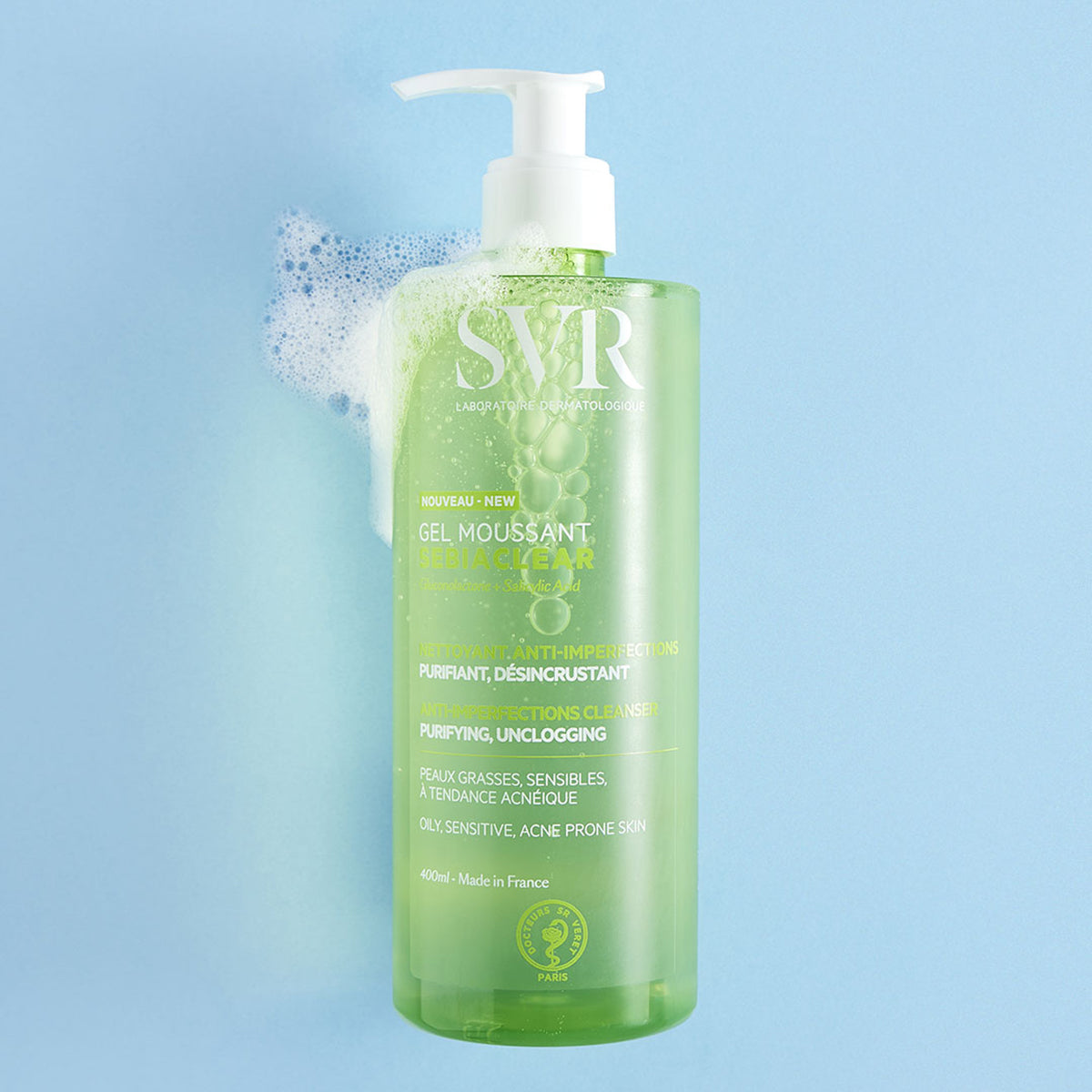 SVR Sebiaclear Gel Moussant 400ml pump bottle with green translucent packaging and white cleansing foam on a blue background.