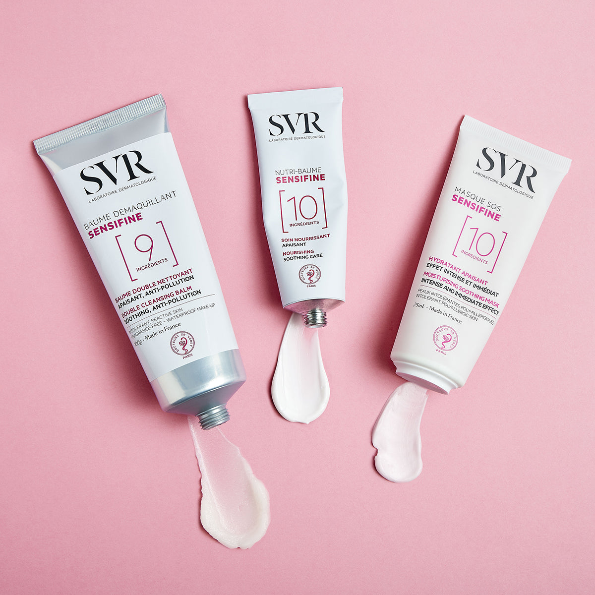 Three SVR Sensifine skincare tubes with white cream swatches on a soft pink background.