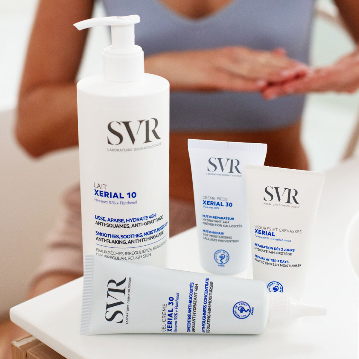 SVR Xerial skincare collection featuring a pump bottle and three white tubes on a white surface.