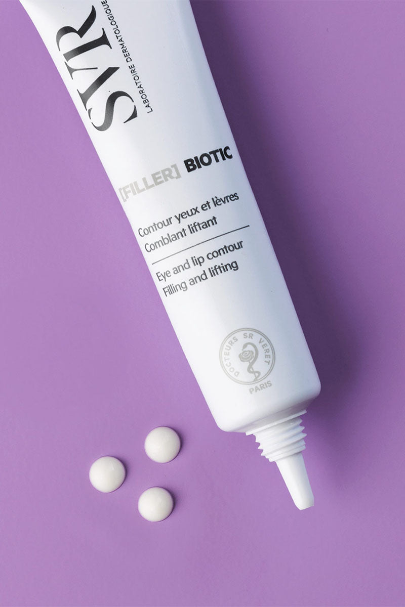 SVR [FILLER] Biotic eye and lip contour cream tube with three white product drops on a purple background.